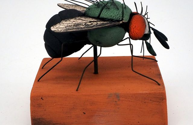 Delicately built - ceramic insect on a pedestal